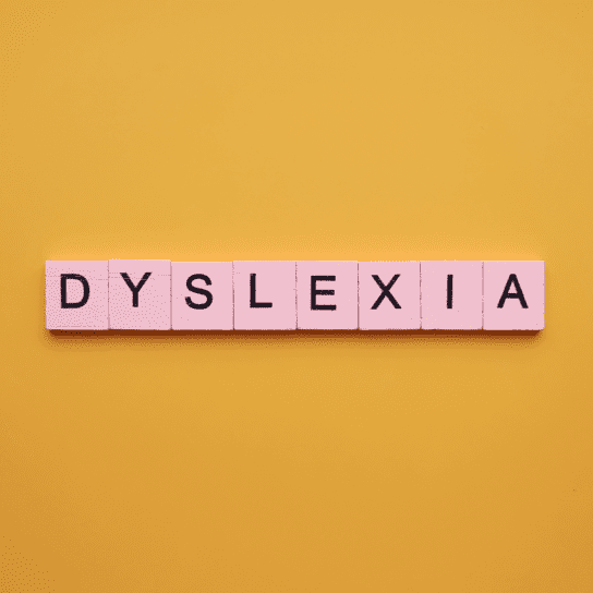 Dyslexia word wooden cubes on an yellow background